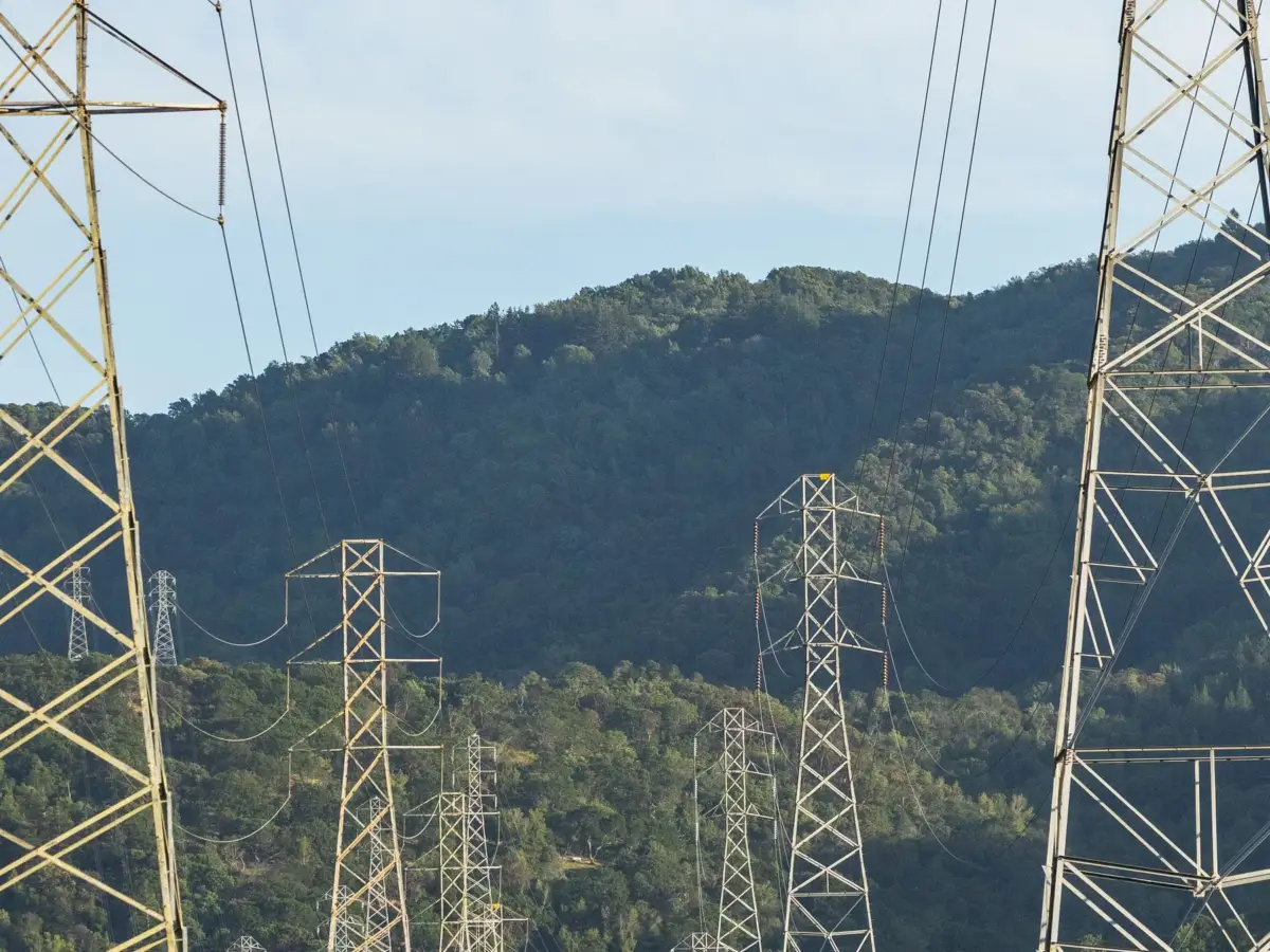 Transmission towers crossing a forested valley, Central America